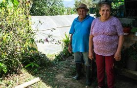 Zwei Begünstigte aus einem Projekt in Kolumbien zeigen zufrieden ihren Garten.